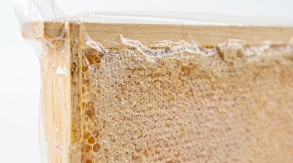 A close-up of the raw capped honeycomb and wooden frame